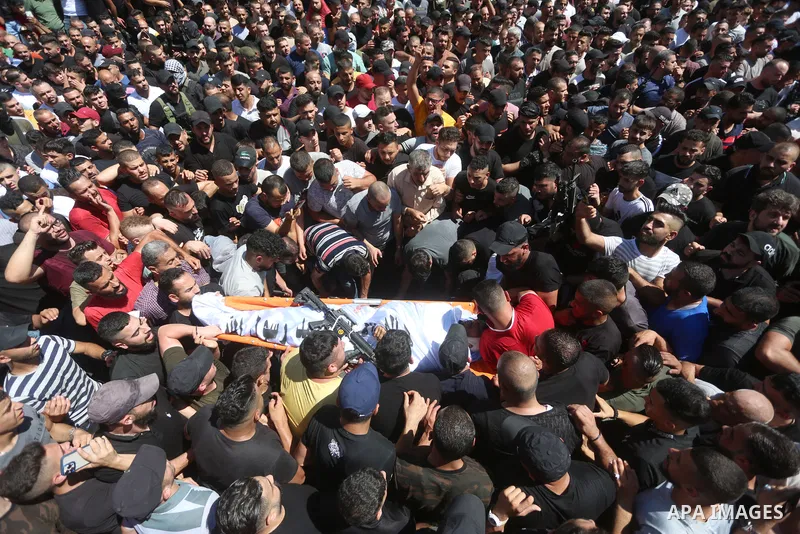 Mourners carry the bodies of two Palestinians who were killed by Israeli forces, during their funeral, in the West Bank city of Nablus on July 24, 2022. Two Palestinians were shot dead last night and ten others wounded,...