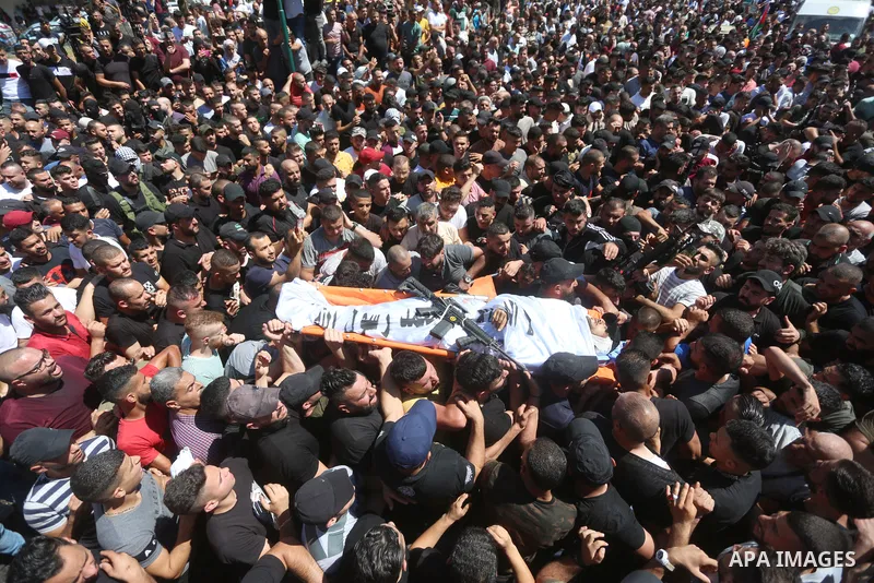 Mourners carry the bodies of two Palestinians who were killed by Israeli forces, during their funeral, in the West Bank city of Nablus on July 24, 2022. Two Palestinians were shot dead last night and ten others wounded,...