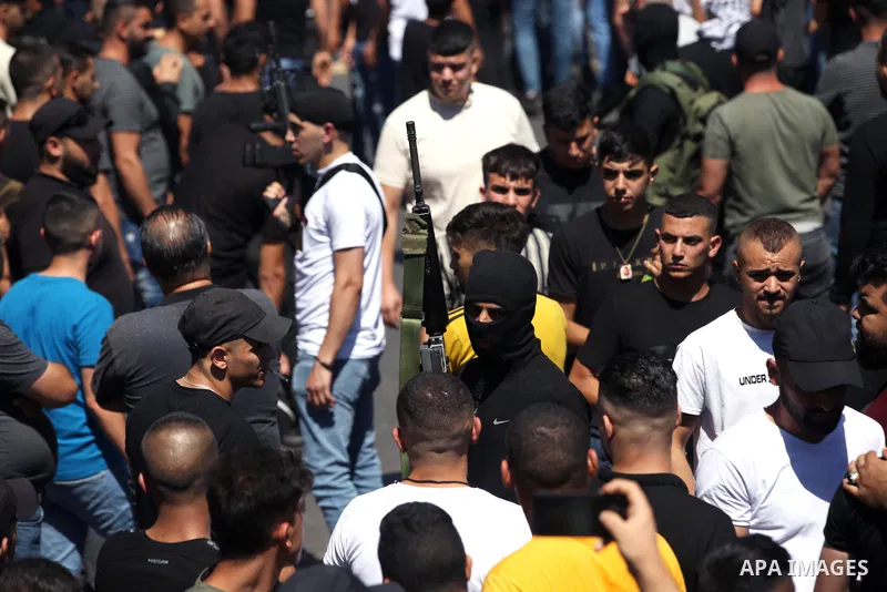 Mourners carry the bodies of two Palestinians who were killed by Israeli forces, during their funeral, in the West Bank city of Nablus on July 24, 2022. Two Palestinians were shot dead last night and ten others wounded,...