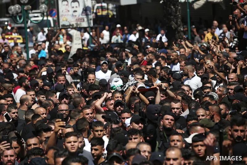 Mourners carry the bodies of two Palestinians who were killed by Israeli forces, during their funeral, in the West Bank city of Nablus on July 24, 2022. Two Palestinians were shot dead last night and ten others wounded,...