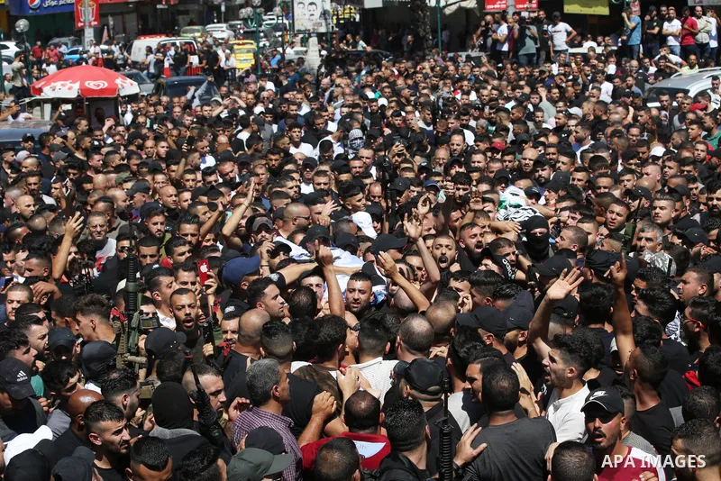 Mourners carry the bodies of two Palestinians who were killed by Israeli forces, during their funeral, in the West Bank city of Nablus on July 24, 2022. Two Palestinians were shot dead last night and ten others wounded,...
