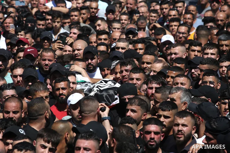 Mourners carry the bodies of two Palestinians who were killed by Israeli forces, during their funeral, in the West Bank city of Nablus on July 24, 2022. Two Palestinians were shot dead last night and ten others wounded,...