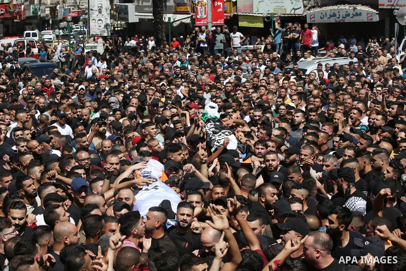 Mourners carry the bodies of two Palestinians who were killed by Israeli forces, during their funeral, in the West Bank city of Nablus on July 24, 2022. Two Palestinians were shot dead last night and ten others wounded,...