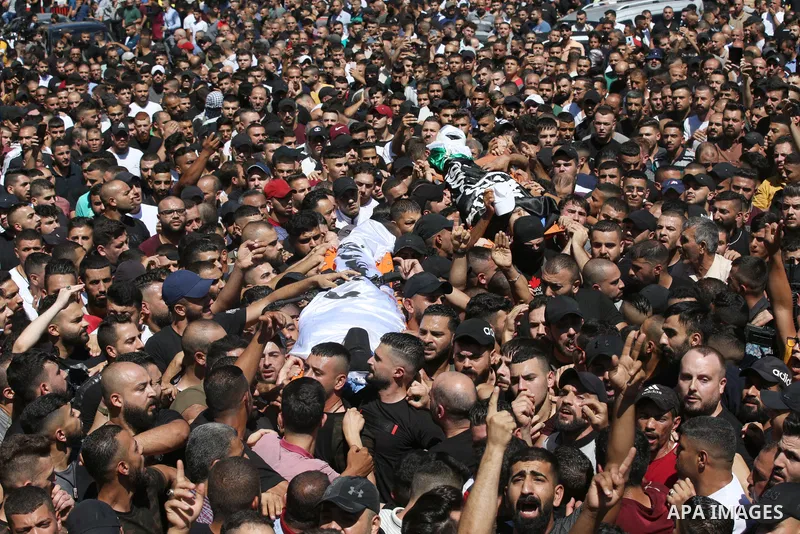 Mourners carry the bodies of two Palestinians who were killed by Israeli forces, during their funeral, in the West Bank city of Nablus on July 24, 2022. Two Palestinians were shot dead last night and ten others wounded,...