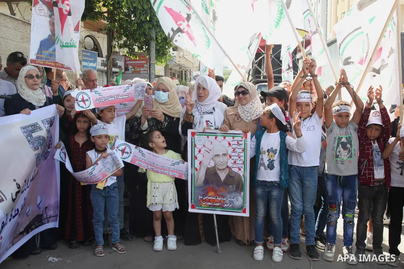 Palestinian supporters of of the popular struggle front, take part in a protest marking the 55th anniversary of its founding, in front of the headquarters of the Red Cross in Gaza City on 25 July 2022. Some 75 Palestinia...