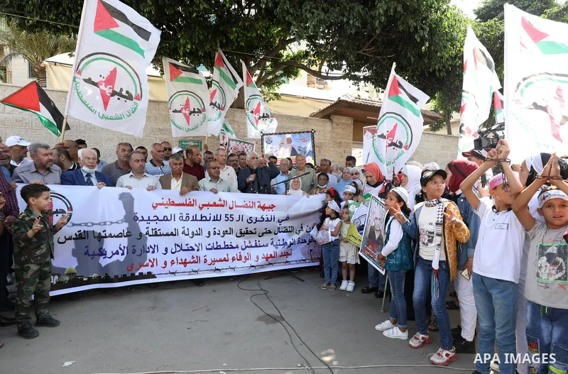 Palestinian supporters of of the popular struggle front, take part in a protest marking the 55th anniversary of its founding, in front of the headquarters of the Red Cross in Gaza City on 25 July 2022. Some 75 Palestinia...