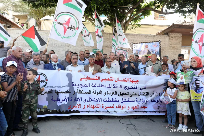 Palestinian supporters of of the popular struggle front, take part in a protest marking the 55th anniversary of its founding, in front of the headquarters of the Red Cross in Gaza City on 25 July 2022. Some 75 Palestinia...