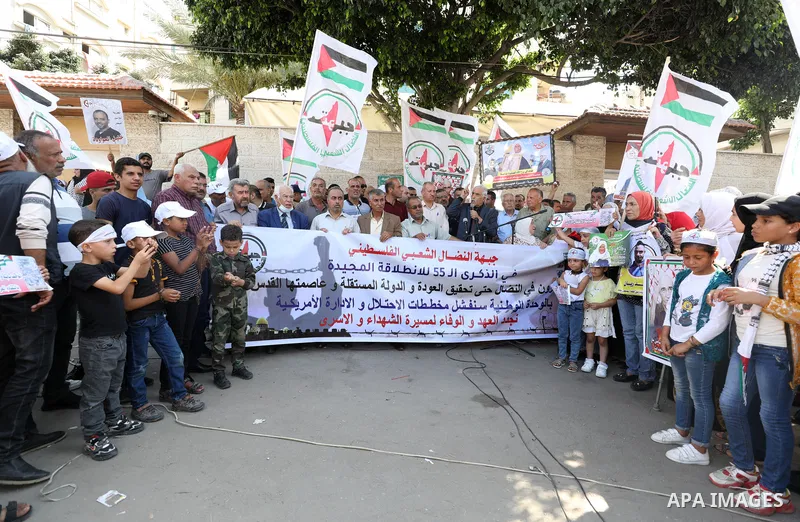 Palestinian supporters of of the popular struggle front, take part in a protest marking the 55th anniversary of its founding, in front of the headquarters of the Red Cross in Gaza City on 25 July 2022. Some 75 Palestinia...