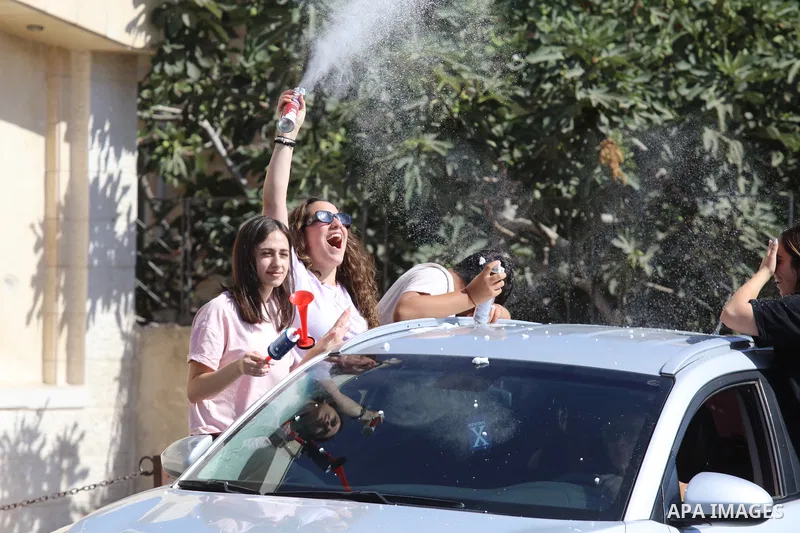 Palestinian high school students celebrate at streets after results the final exams known as "Tawjihi", in the West bank city of Bethlehem on July 30, 2022. Photo by Ahmad Tayem