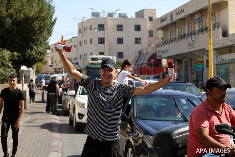 Palestinian high school students celebrate at streets after results the final exams known as "Tawjihi", in the West bank city of Bethlehem on July 30, 2022. Photo by Ahmad Tayem