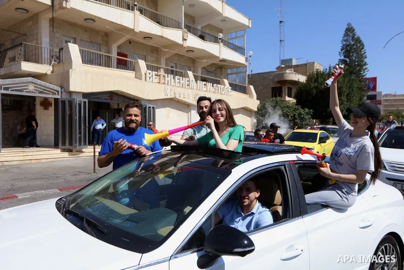 Palestinian high school students celebrate at streets after results the final exams known as "Tawjihi", in the West bank city of Bethlehem on July 30, 2022. Photo by Ahmad Tayem