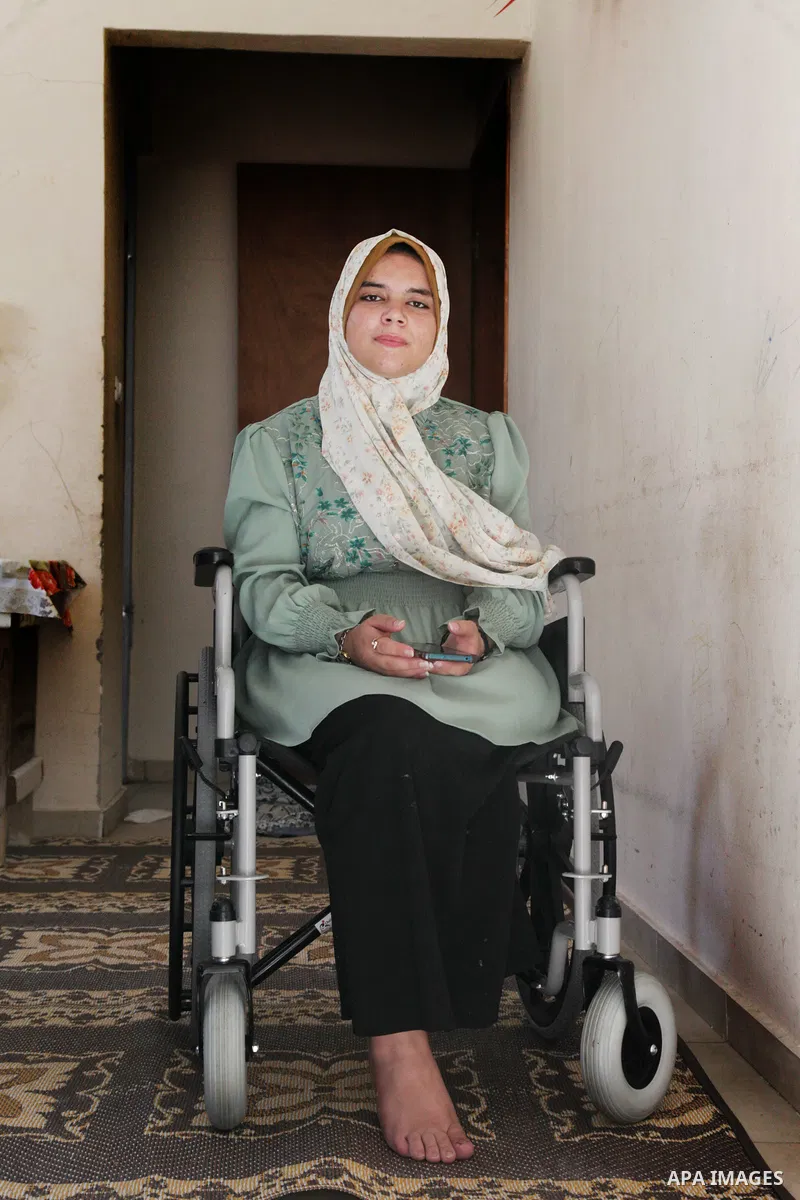 A Palestinian high school female Maryam Abed Rabbo, Cancer patient sitting in a wheelchair, received an average of 89.1%, celebrates with her family after the results of her final exams known as ''Tawjihi", in Jabalia in...