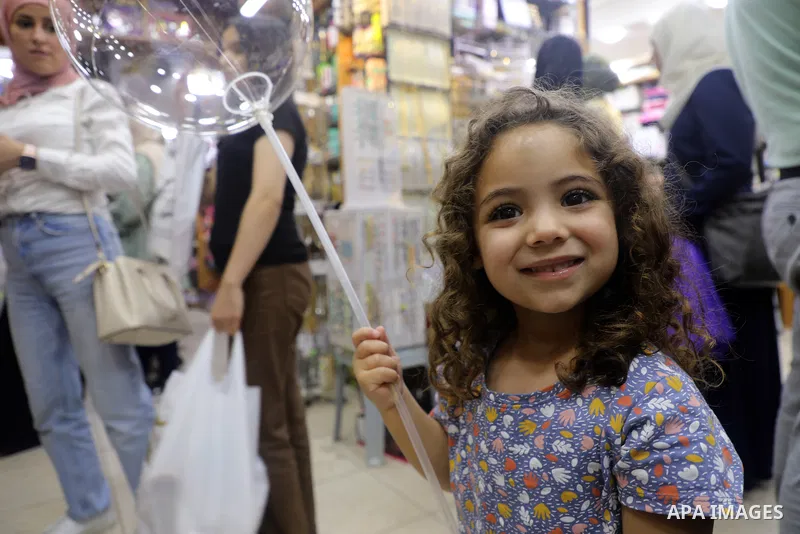 Palestinians shop at a market ahead of the Muslim festival of sacrifice Eid al-Adha, in the West Bank city of Ramallah on July 7, 2022. Eid al-Adha, or the feast of sacrifice, falls at this month when Muslims will slaugh...