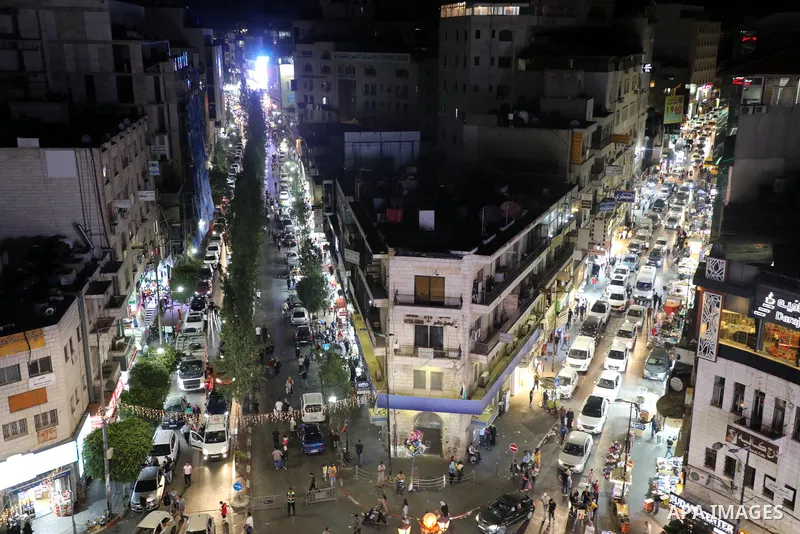 Palestinians shop at a market ahead of the Muslim festival of sacrifice Eid al-Adha, in the West Bank city of Ramallah on July 7, 2022. Eid al-Adha, or the feast of sacrifice, falls at this month when Muslims will slaugh...