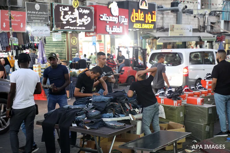 Palestinians shop at a market ahead of the Muslim festival of sacrifice Eid al-Adha, in the West Bank city of Ramallah on July 7, 2022. Eid al-Adha, or the feast of sacrifice, falls at this month when Muslims will slaugh...