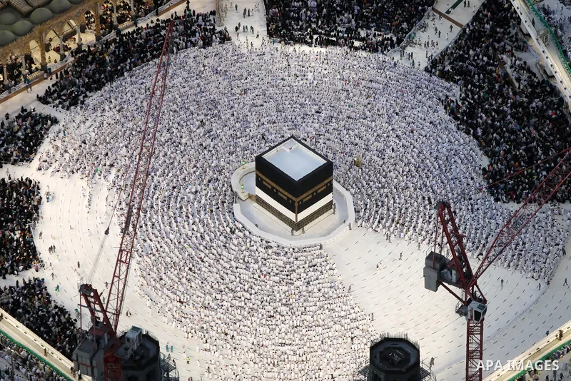 Muslim worshippers are seen pray around the Kaaba at the Grand Mosque from the Abraj Al-Bait Towers also known as the Mecca Royal Hotel Clock Tower, in Saudi Arabia's holy city of Mecca, on July 6, 2022. One million peop...
