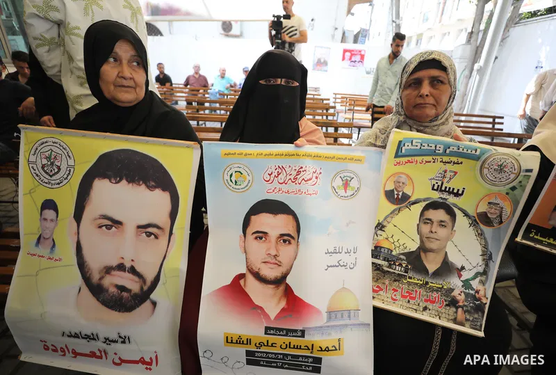 Palestinians take part in a protest to show solidarity with prisoners on hunger strike held in Israeli jails, in front of Red cross office in Gaza city, on June 27, 2022. Amnesty International, has described Israel's adm...
