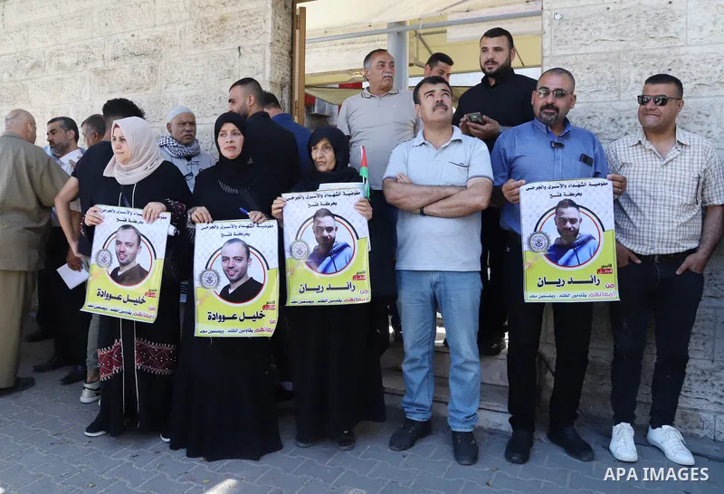 Palestinians take part in a protest in solidarity with prisoners on hunger strike in Israeli jails, in front of Red cross office in Gaza City on June 13, 2022. Two Palestinian administrative detainees in Israeli prisons...
