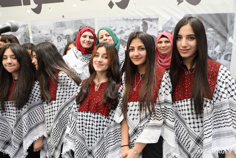 Palestinians wave national flags as they march in a rally marking the 74th anniversary of the "Nakba" or "catastrophe", in the West Bank city of Ramallah, on May 15, 2022. Each year Palestinians commemorate the "Nakba" o...