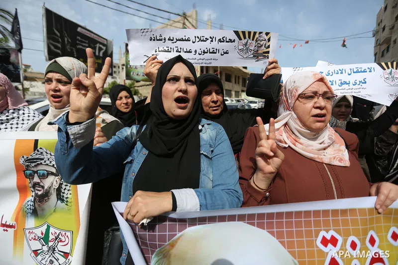 Palestinians take part in a protest in solidarity with prisoners in Israeli Jails in front of Red Cross office on May 9, 2022. The occupation stalls in providing treatment for prisoners, including the deliberate indiffer...