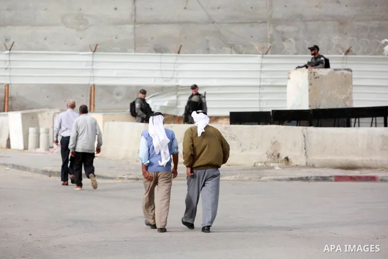 Palestinian Muslim worshippers are pictured at an Israeli controlled Qalandia checkpoint as they make their way to attend the first Friday prayers of Ramadan in Jerusalem's Al-Aqsa mosque, near the West Bank city of Rama...