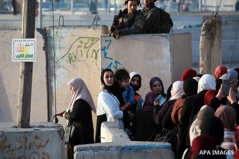 Palestinian Muslim worshippers are pictured at an Israeli controlled Qalandia checkpoint as they make their way to attend the third Friday prayers of Ramadan in Jerusalem's Al-Aqsa mosque, near the West Bank city of Rama...