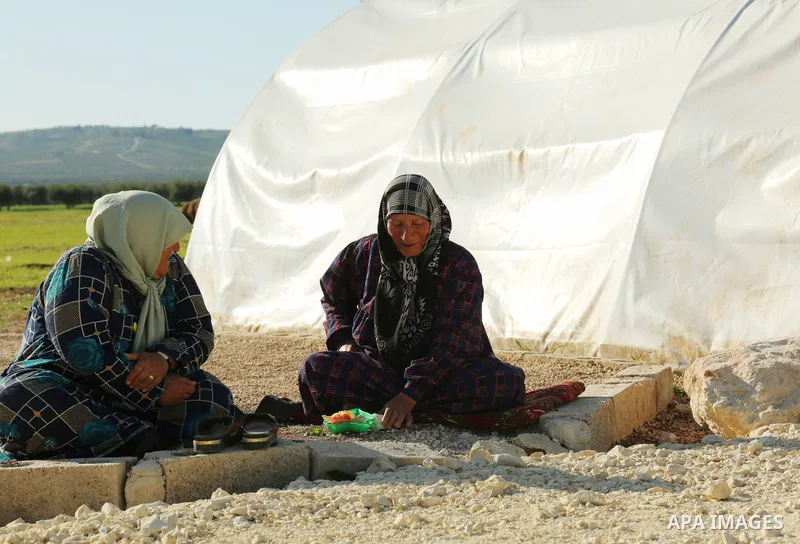 Syrian refugees play near their tents during the Muslims holy month of Ramadan, at Awtad camp north of Azaz on Syria's northern border with Turkey, on April 19, 2022. Photo by Samir Abed