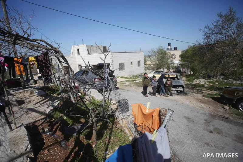 Palestinians inspect burned vehicles in an arson attack by Israeli settlers near the West Bank village of Jalud southern Nablus on March 28, 2022. Israeli settlers last night sneaked into the northern West Bank village o...