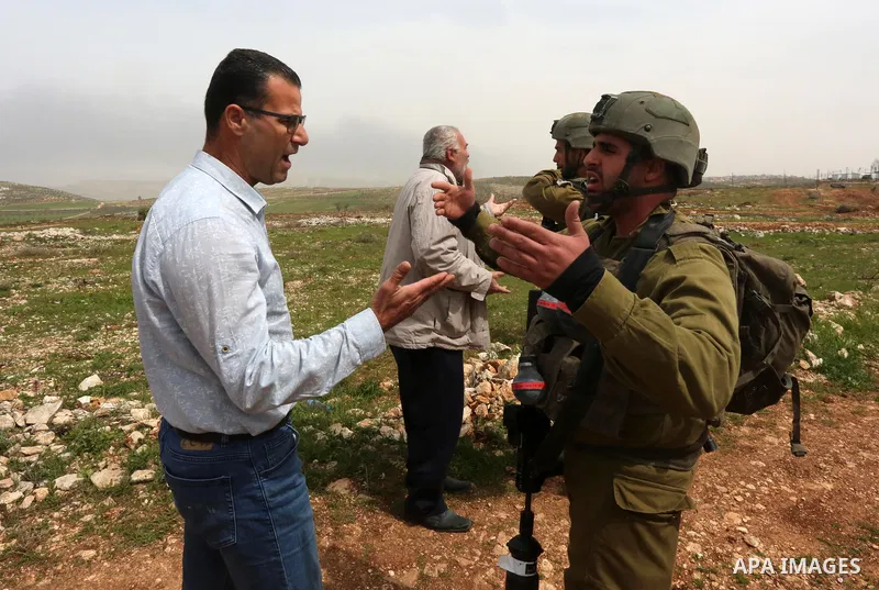 Palestinian farmers scuffle with Israeli security forces which preventing them plant olive trees on their land marking the Palestinian Land Day, at Qusra village near the West Bank City of Nablus on March 29, 2022. Photo...