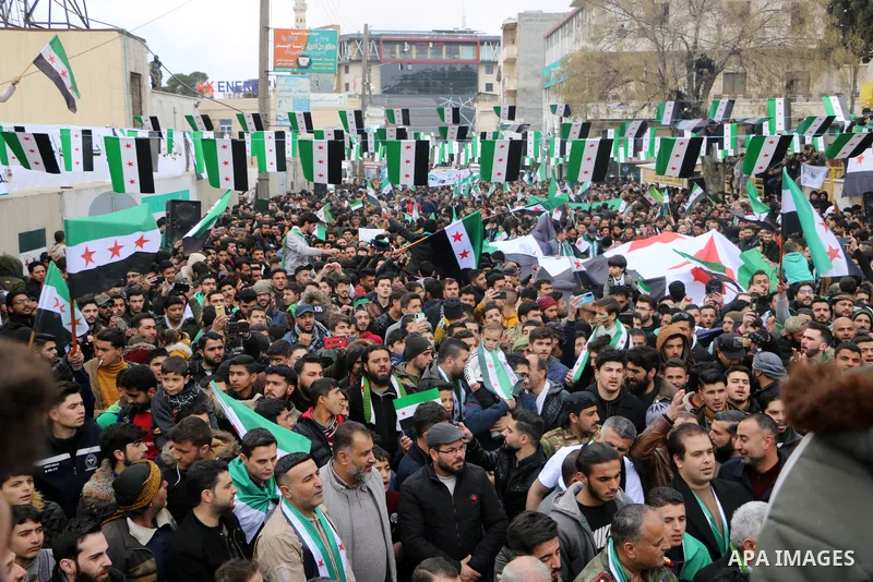 Syrians chant and hold banners during a rally marking 11 years since the start of an anti-regime uprising in the city of Azaz, northern countryside of Syria's Aleppo province, on March 15, 2022. Photo by Samir Abed