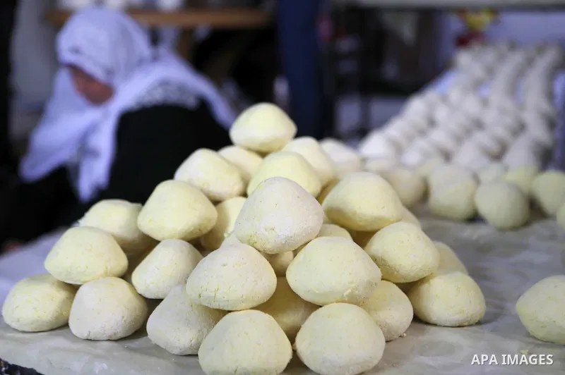 Palestinian family make Jameed in Masafer Yatta, south of Hebron, in the southern West Bank on March 23, 2022. Jameed dry fermented yogurt made from ewe or goat's milk. Jameed is the primary ingredient used to make mansa...
