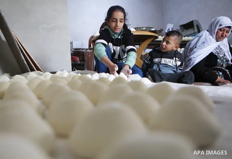 Palestinian family make Jameed in Masafer Yatta, south of Hebron, in the southern West Bank on March 23, 2022. Jameed dry fermented yogurt made from ewe or goat's milk. Jameed is the primary ingredient used to make mansa...