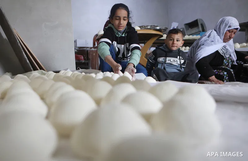 Palestinian family make Jameed in Masafer Yatta, south of Hebron, in the southern West Bank on March 23, 2022. Jameed dry fermented yogurt made from ewe or goat's milk. Jameed is the primary ingredient used to make mansa...