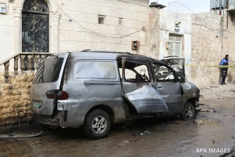 Security forces inspect the scene of an explosion that targeted the vehicle of and killed a member of the Syrian fighters in Syria's town of Azaz in northern countryside of Syria's Aleppo province near the border with Tu...