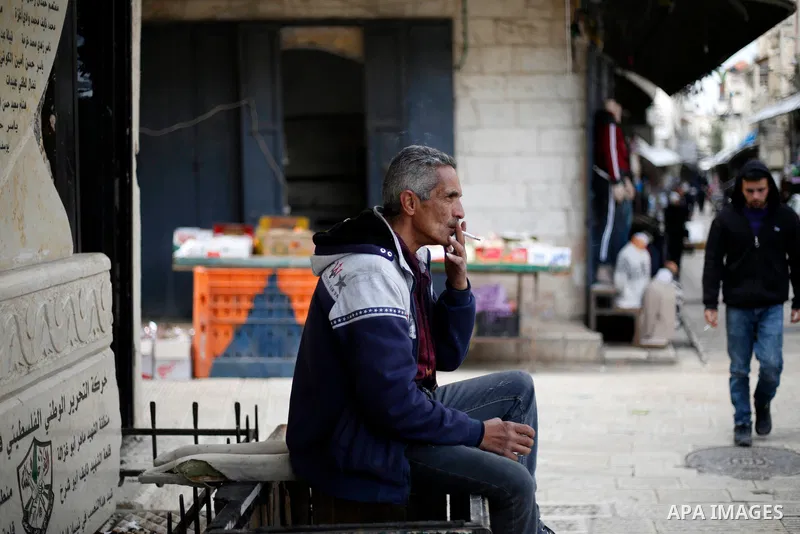 Palestinians shop at a market in the Old city of the West Bank city of Nablus on January 31, 2022. Photo by Shadi Jarar'ah