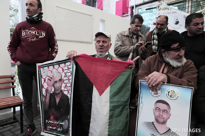 Palestinians take part in a protest in solidarity with prisoners in Israeli jails, in front of Red Cross office in Gaza city on January 31, 2022. Photo by Youssef Abu Watfa