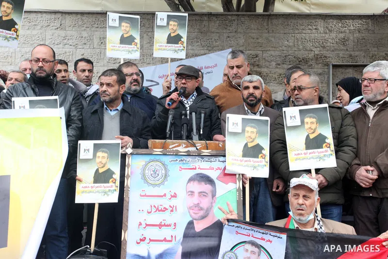 Palestinians take part in a protest in solidarity with prisoners in Israeli jails, in front of Red Cross office in Gaza city on January 31, 2022. Photo by Youssef Abu Watfa