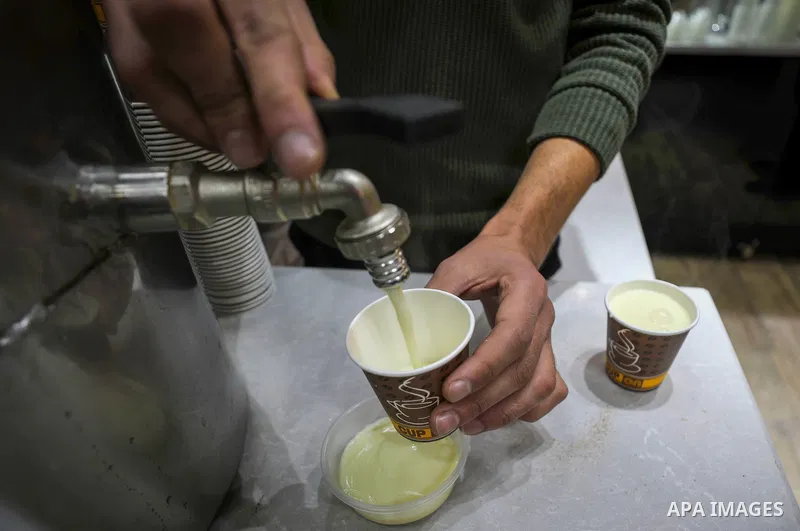 A Palestinian vendor prepares Sahlab (a hot drink for winter) to sell for customers in Gaza city of January 30, 2022. Photo by Mahmoud Nasser