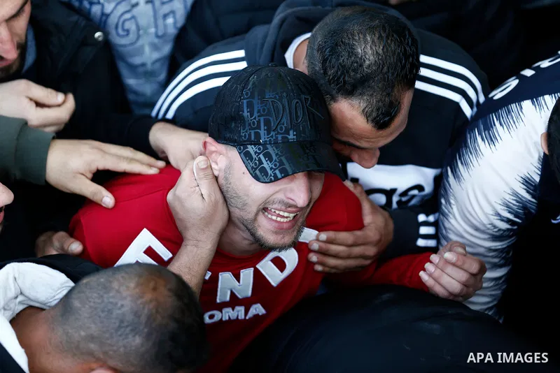 Mourners attend the funeral of Palestinian Mustafa Falaneh, 25, who was killed after an Israeli settler rammed him by his vehicle, in the West Bank city of Ramallah on January 6, 2022. Photo by Ibrahim Atta