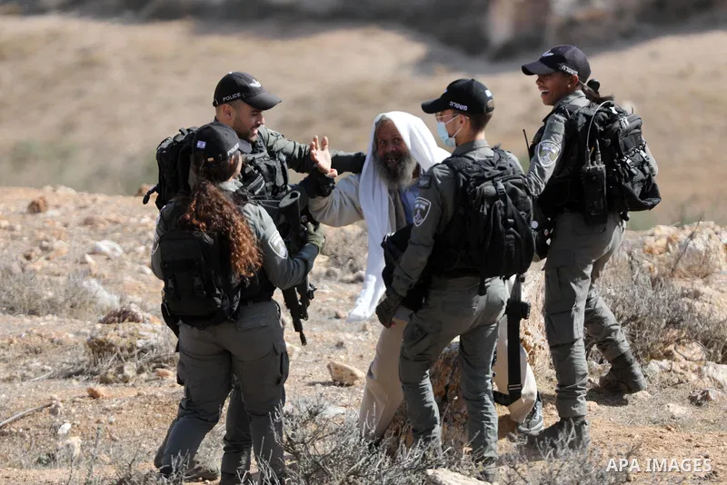 Palestinian man confronts Israeli soldiers during the demolition of his house located under the pretext of building without a permit in Yatta south of Hebron in the West Bank, on December 06, 2021. According to a report...