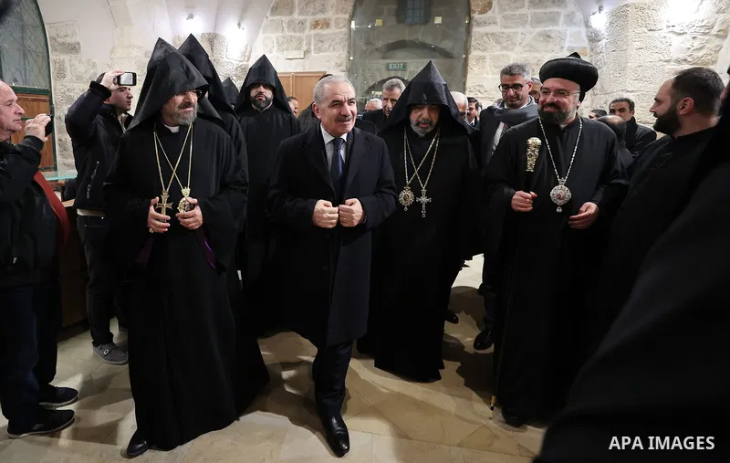 Palestinian Prime Minister Mohammad Shtayyeh with Armenian Orthodox attend to celebrate Christmas and Epiphany in the West Bank city of Bethlehem, on January 18, 2023. Photo by Shadi Hatem\ apaimages