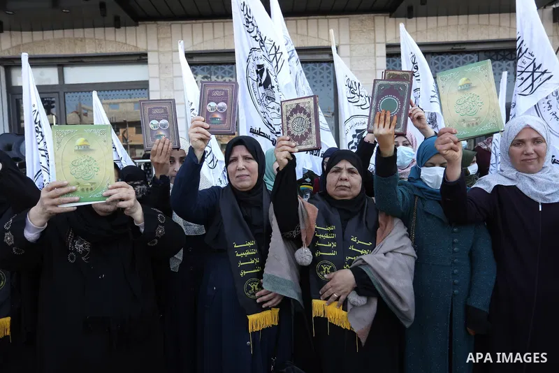 Palestinians hold Koran during a protest the burning of a copy of the Muslim holy book of Koran by a far-right politician Outside the Turkish Embassy in Stockholm in the Nuseirat refugee camp in the central Gaza Strip on...