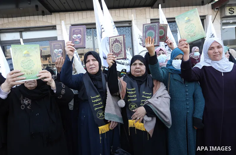 Palestinians hold Koran during a protest the burning of a copy of the Muslim holy book of Koran by a far-right politician Outside the Turkish Embassy in Stockholm in the Nuseirat refugee camp in the central Gaza Strip on...