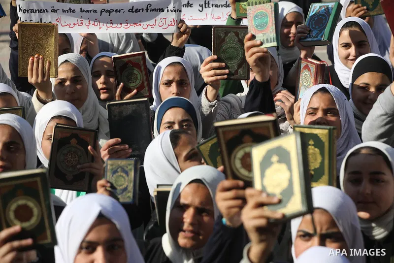 Palestinian students take part in a protest the burning of a copy of the Muslim holy book of Koran by a far-right politician Outside the Turkish Embassy in Stockholm at their school in Khan Yunis, in the southern Gaza St...