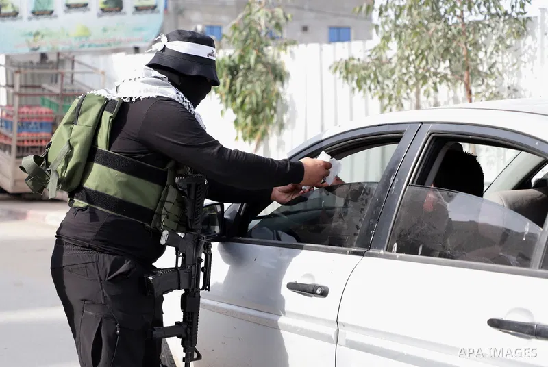Militants from the Al-Aqsa Martyrs Brigades, the military wing of Fatah movement, distribute sweets celebrating following reports that two Israeli shot and wounded in a shooting attack in Silwan neighborhood, in the West...