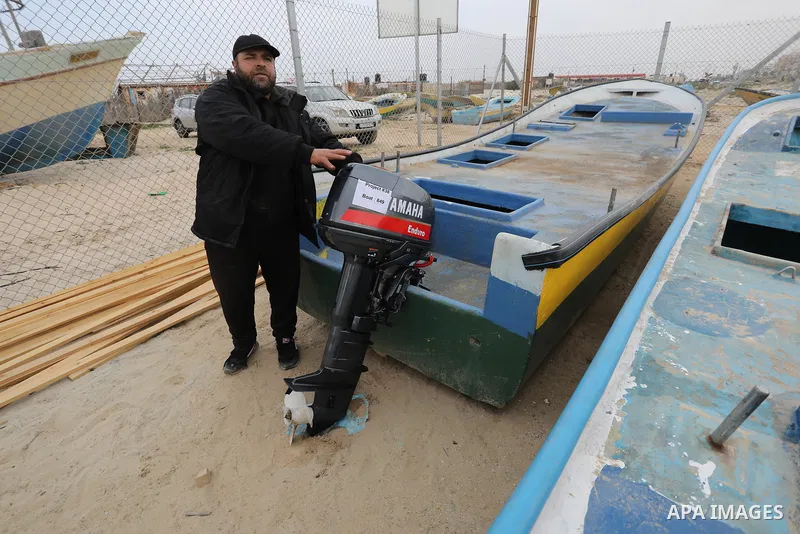Palestinians fishermen get new outboard engine for their boats at Gaza port on January 29, 2023. Marooned for a decade by engine failure, Palestinian fishermen will finally be able to return to sea with a new outboard mo...