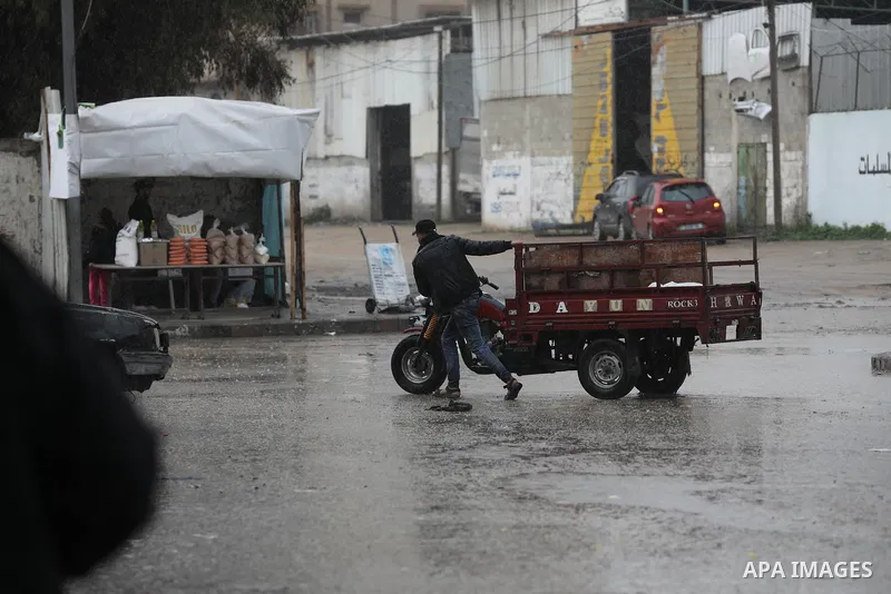 Palestinians walk at streets during during a stormy day in the Palestinian coastal enclave on January 31, 2023. Photo by Ashraf Amra\ apaimages