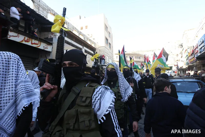 Militants from the Al-Aqsa Martyrs Brigades, the military wing of Fatah movement, take part in a military parade in the West Bank city of Nablus on February 11, 2023. Photo by Shadi Jarar'ah\ apaimages