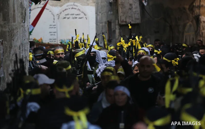 Militants from the Al-Aqsa Martyrs Brigades, the military wing of Fatah movement, take part in a military parade in the West Bank city of Nablus on February 11, 2023. Photo by Shadi Jarar'ah\ apaimages