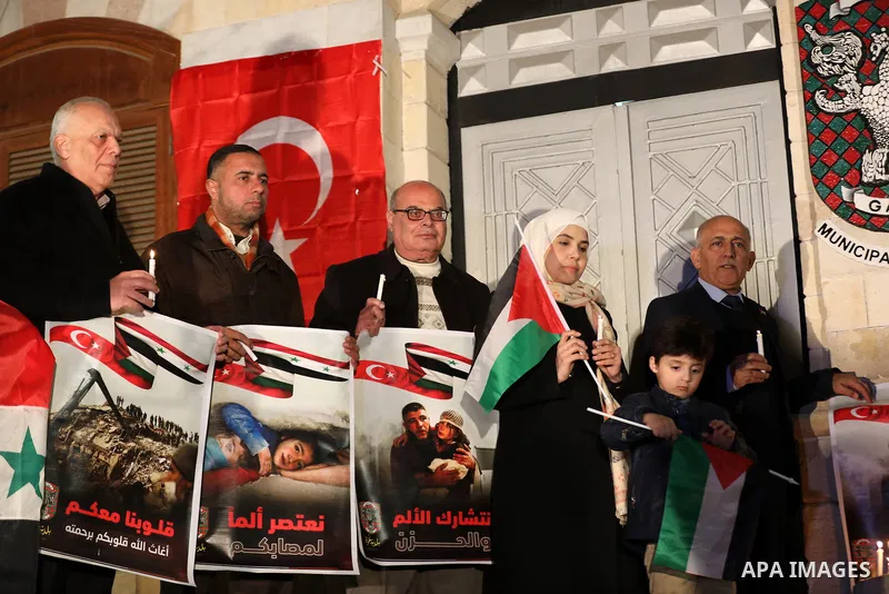 Palestinians light candles during a gathering in solidarity with the people of Turkey and Syria following a devastating earthquake, in Gaza city on Feb. 13, 2023. A 7.8-magnitude earthquake hit Turkey and Syria on Februa...